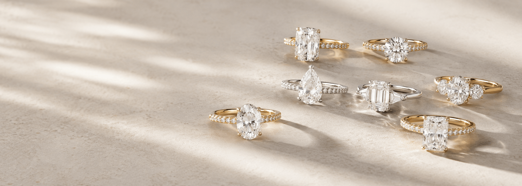 rings on a tan table with sun shining on them 