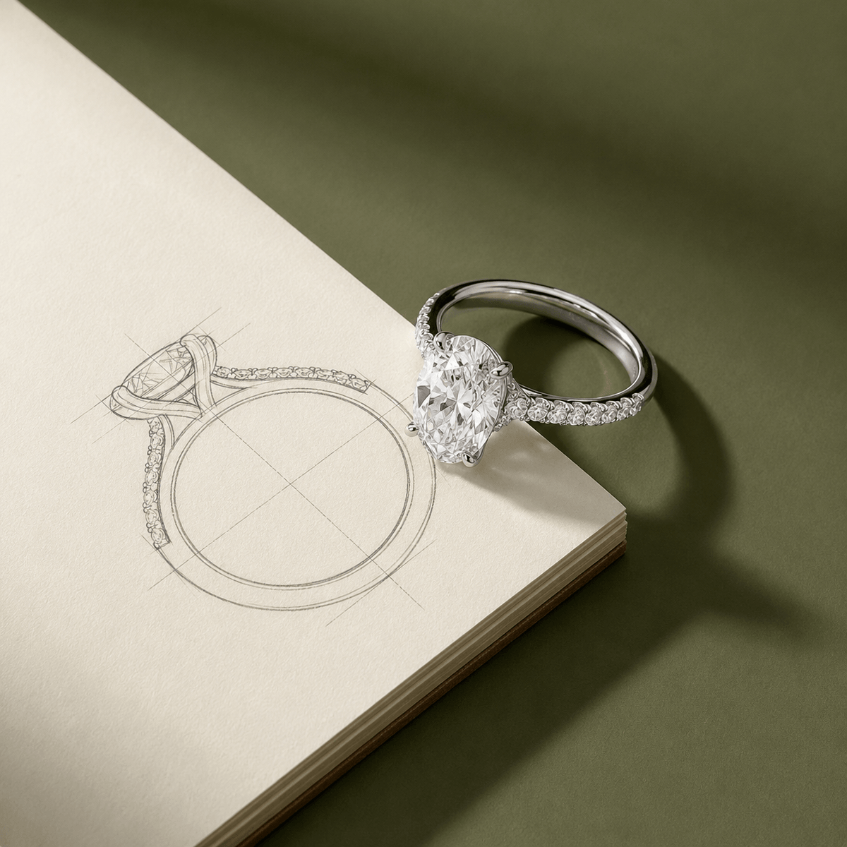 White Gold Oval Diamond Engagement Ring Next To the Concept Drawings Of The Ring Done By Waco Diamonds In Waco TX